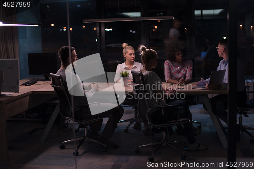 Image of Multiethnic startup business team in night office