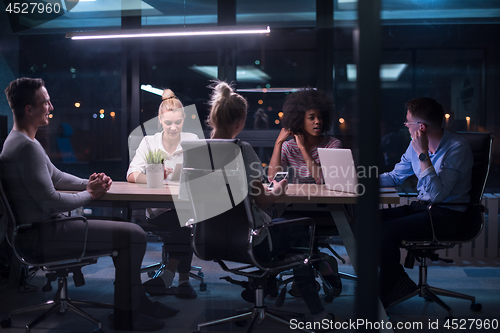 Image of Multiethnic startup business team in night office