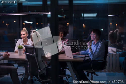 Image of Multiethnic startup business team in night office
