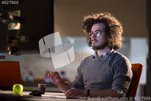 Image of Tired businessman working late