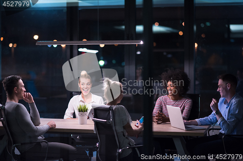 Image of Multiethnic startup business team in night office
