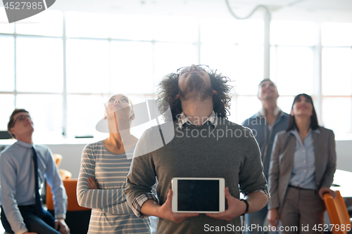 Image of Portrait of a young businessman holding tablet