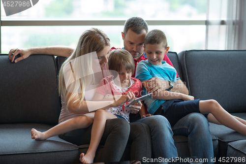 Image of happy young couple spending time with kids