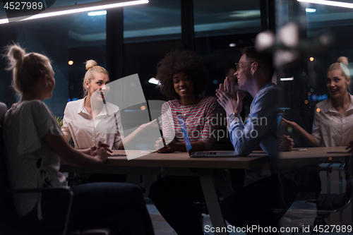 Image of Multiethnic startup business team in night office