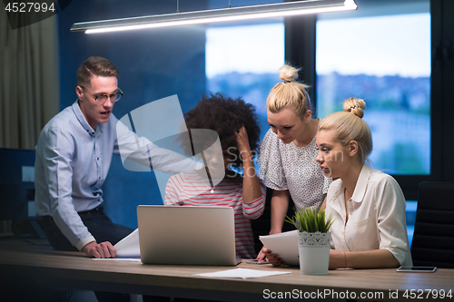 Image of Multiethnic startup business team in night office