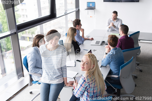 Image of Pretty Businesswomen Using Tablet In Office Building during conf