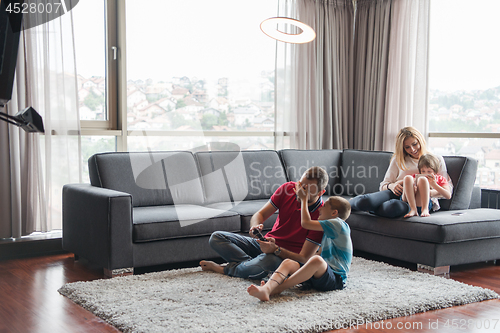 Image of Happy family playing a video game