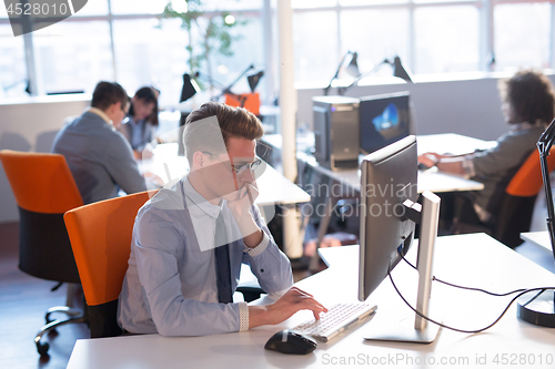 Image of businessman working using a computer in startup office