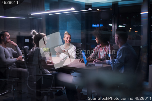 Image of Multiethnic startup business team in night office