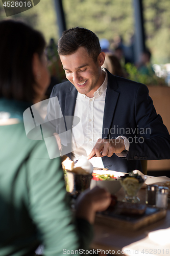 Image of Closeup shot of young woman and man having meal.