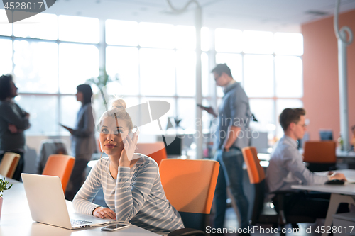 Image of businesswoman using a laptop in startup office