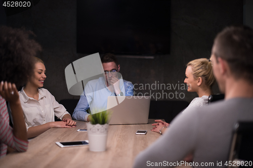 Image of Multiethnic startup business team in night office