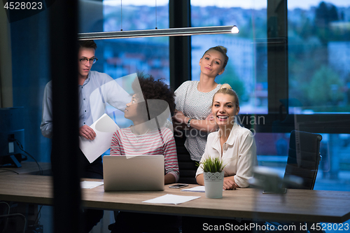 Image of Multiethnic startup business team in night office