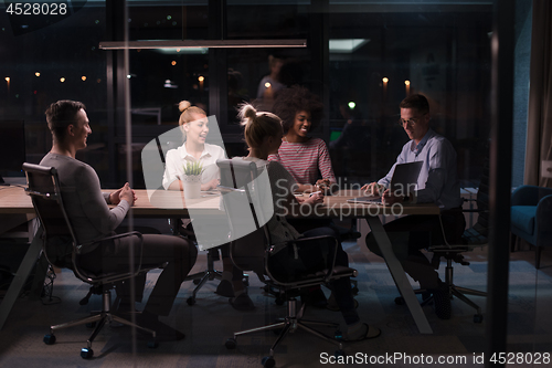 Image of Multiethnic startup business team in night office