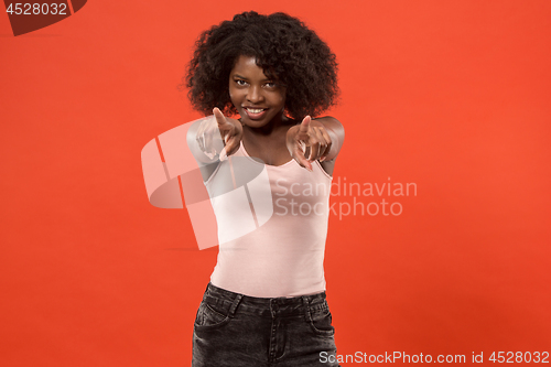Image of The happy business woman point you and want you, half length closeup portrait on red background.