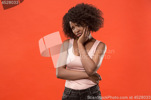 Image of Beautiful woman looking suprised and bewildered isolated on red