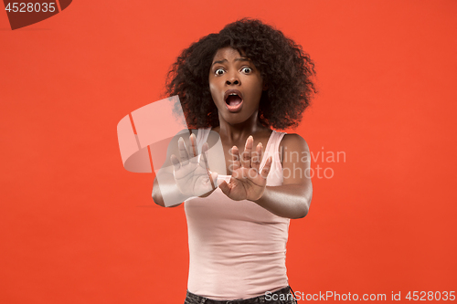 Image of Portrait of the scared woman on red