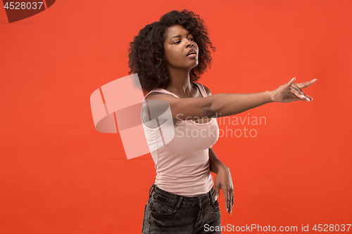 Image of The overbearing business woman point you and want you, half length closeup portrait on red background.