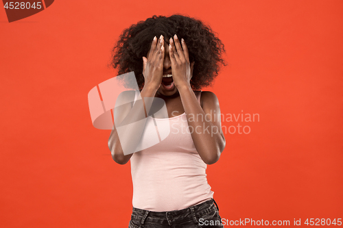 Image of Portrait of the scared woman on red