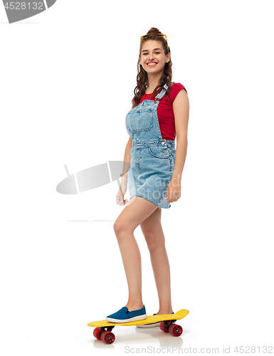 Image of smiling teenage girl with skateboard over white