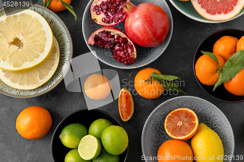 Image of close up of citrus in bowls fruits on stone table