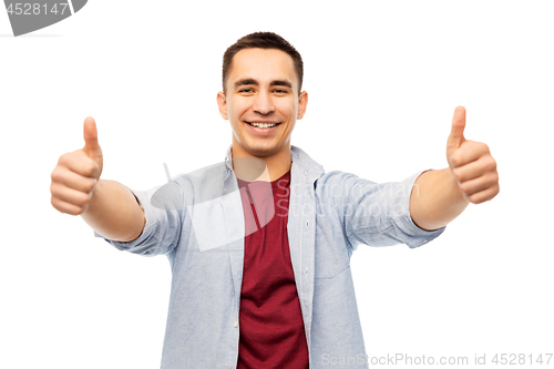 Image of happy young man showing thumbs up