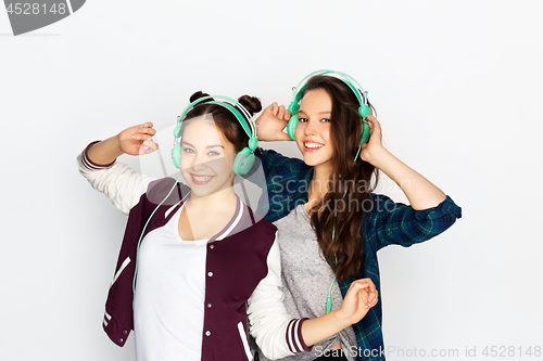 Image of teenage girls in earphones listening to music