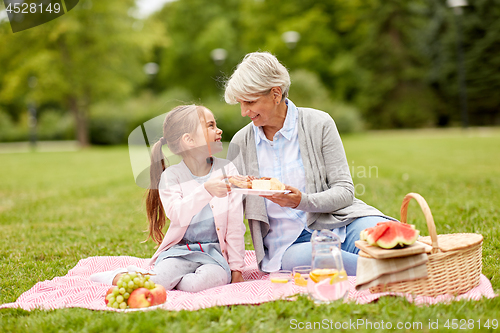 Image of grandmother and granddaughter at picnic in park