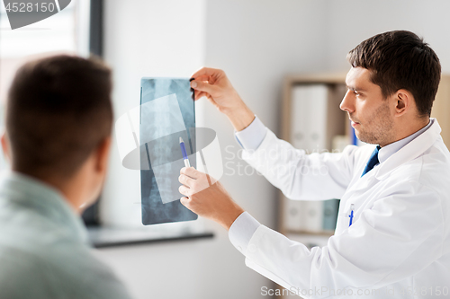 Image of doctor showing x-ray to patient at hospital