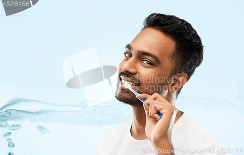 Image of indian man with toothbrush cleaning teeth