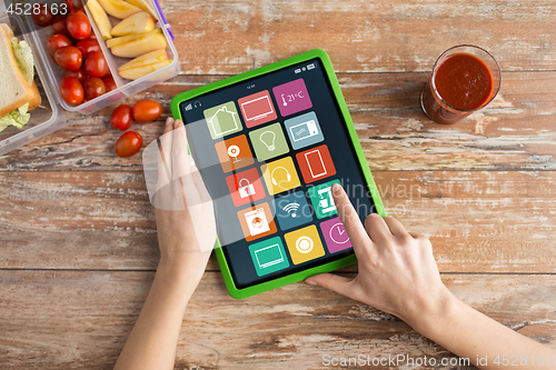 Image of hands with smart home icons on tablet computer