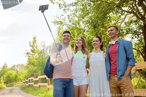 Image of friends take picture by smartphone on selfie stick