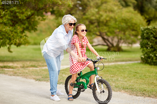 Image of grandmother and granddaughter with bicycles