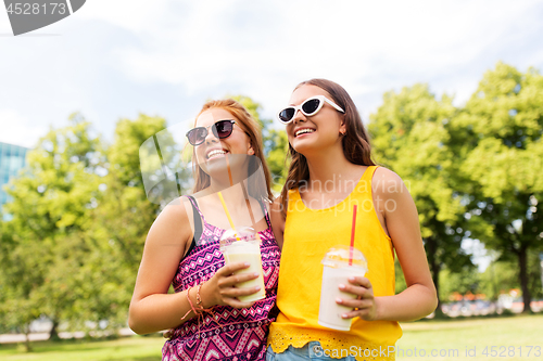 Image of teenage girls with milk shakes at summer park