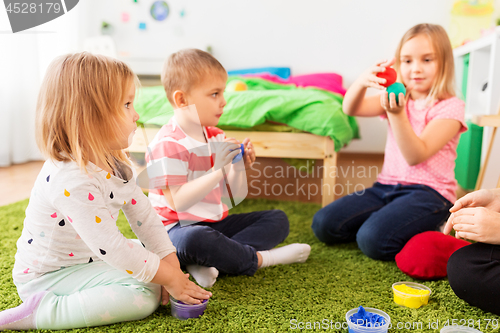 Image of children with modelling clay or slimes at home