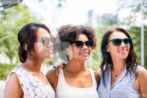 Image of happy young women in sunglasses at summer park