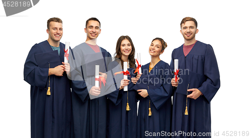 Image of graduates in mortar boards with diplomas