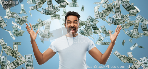 Image of indian man celebrating triumph over money falling