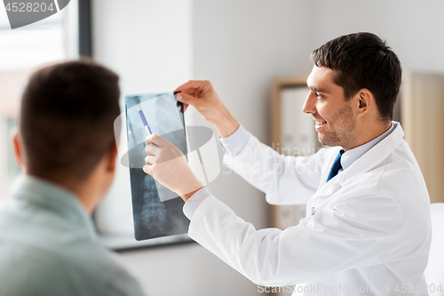 Image of doctor showing x-ray to patient at hospital