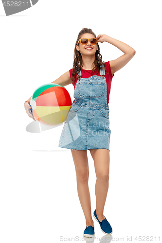 Image of smiling teenage girl in sunglasses with beach ball