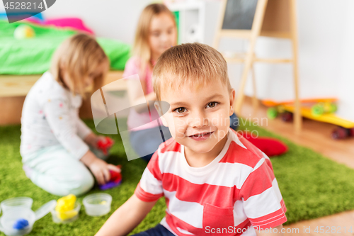 Image of boy and other children playing at home