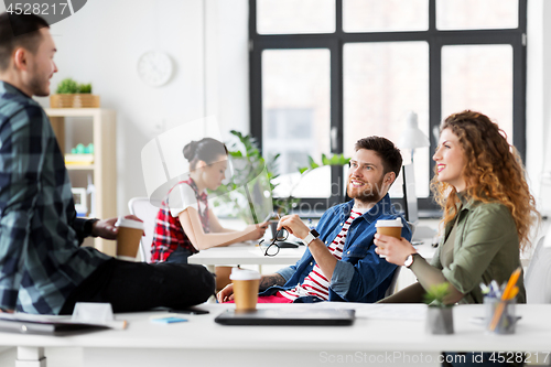 Image of creative team drinking coffee at office