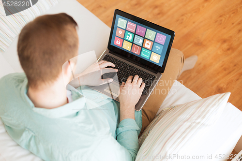 Image of man with smart home icons on laptop computer