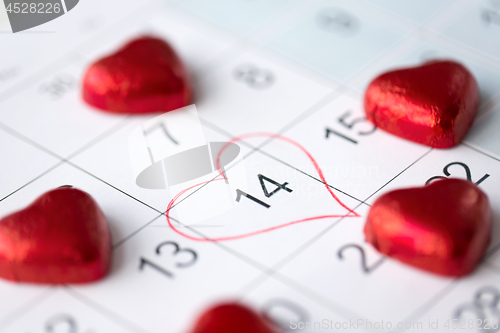 Image of close up of calendar and heart shaped candies