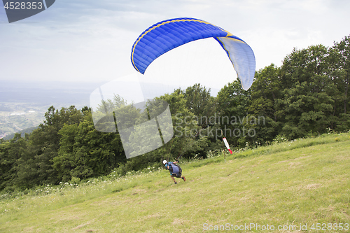 Image of Paraglider taking off from the edge of the mountain