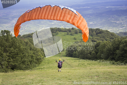 Image of Paraglider taking off from the edge of the mountain