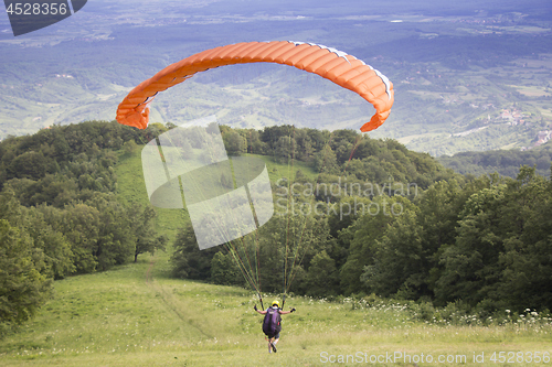 Image of Paraglider taking off from the edge of the mountain