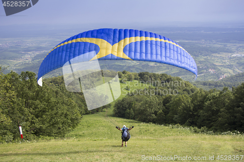 Image of Paraglider taking off from the edge of the mountain