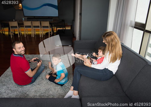 Image of Happy family playing a video game