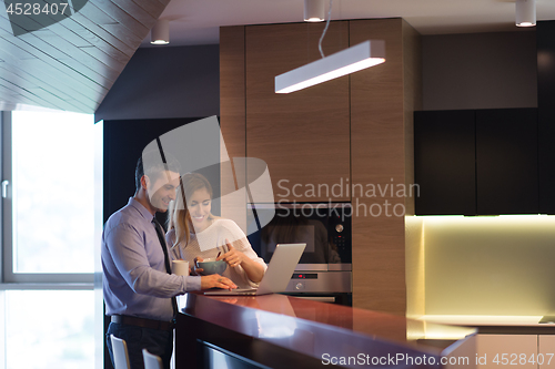 Image of A young couple is preparing for a job and using a laptop